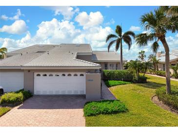 Attractive condo with 2-car garage, nicely landscaped, and walkway at 3491 Byron Ln, Longboat Key, FL 34228