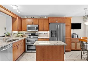 Modern kitchen with granite countertops and stainless steel appliances at 4440 Fairways Blvd # 206, Bradenton, FL 34209