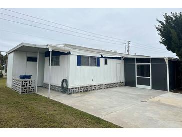 Mobile home with carport and screened enclosure in a residential neighborhood at 4509 10Th Street E Ct, Ellenton, FL 34222