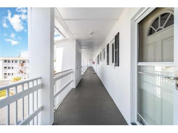 Clean and bright hallway with white walls and white railings at 5907 Todd St # E36, Bradenton, FL 34207