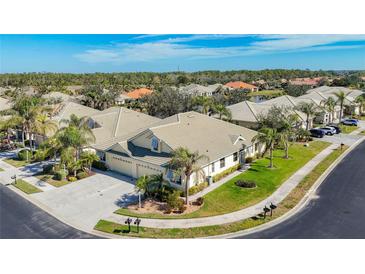 Aerial view of a charming villa community showcasing well-maintained homes and lush landscaping at 9367 Hawk Nest Ln, North Port, FL 34287