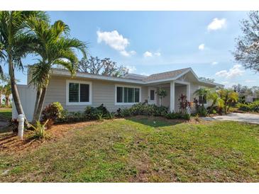 Updated single-story home with a landscaped lawn and attractive facade at 939 Cronley Pl, Sarasota, FL 34237