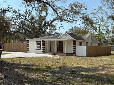 Newly renovated house with a fenced yard and a paved driveway at 1610 24Th St, Sarasota, FL 34234