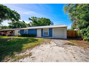 Newly renovated blue house with a metal roof and a two-car garage at 3110 Elmer St, Sarasota, FL 34231