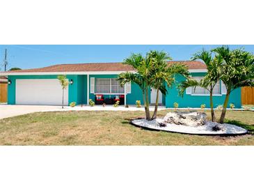 Charming teal home with white trim, landscaping, and a two-car garage at 4010 18Th W Ave, Bradenton, FL 34205