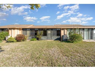 The backyard features a well-maintained lawn and a covered porch at 6314 29Th W Ave, Bradenton, FL 34209