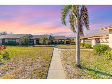 Charming villa-style building with a palm tree and lush landscaping, offering a serene and inviting curb appeal at 6314 29Th W Ave, Bradenton, FL 34209