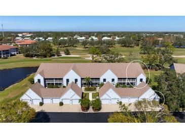Scenic aerial view of townhomes featuring attached garages, landscaping, and golf course in the background at 6609 Stone River Rd # 206, Bradenton, FL 34203