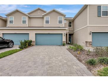 Townhouse exterior featuring a two-car garage and landscaped front yard at 11630 Woodleaf Dr, Bradenton, FL 34211