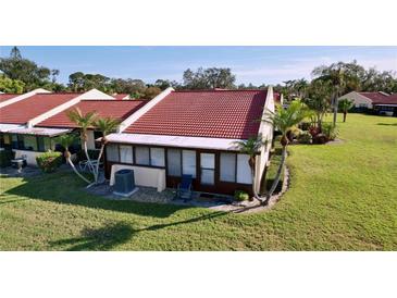 Charming single-story home featuring a red tile roof, screened lanai, and well-maintained landscaping at 1210 56Th W St # 1210, Bradenton, FL 34209