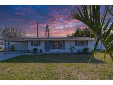 Updated ranch home with landscaped yard and carport at 1752 Banyan Dr, Venice, FL 34293