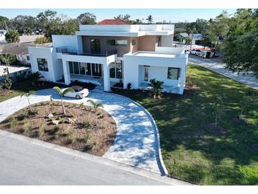 Modern two-story home with circular driveway and landscaped lawn at 2110 Michele Dr, Sarasota, FL 34231