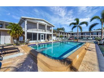 Community pool with surrounding lounge chairs and patio area at 3101 Bee Ridge Rd # 118, Sarasota, FL 34239