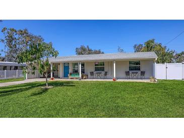 Charming single-story home with a well-manicured front yard and a welcoming covered porch at 3302 21St Avenue W Dr, Bradenton, FL 34205