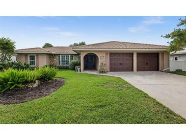 Attractive single-story home with a two-car garage and well-manicured lawn at 416 Giovanni Dr, Nokomis, FL 34275