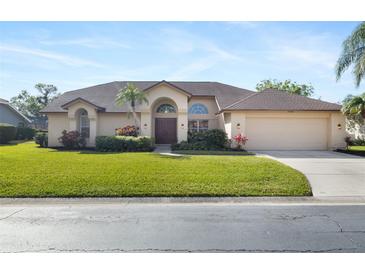 Single-story house with a two-car garage and well-maintained lawn at 4901 Fallcrest Cir, Sarasota, FL 34233