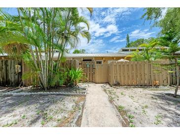 Attractive front yard with walkway, wooden fence, and lush landscaping at 500 N Jefferson Ave # C3, Sarasota, FL 34237