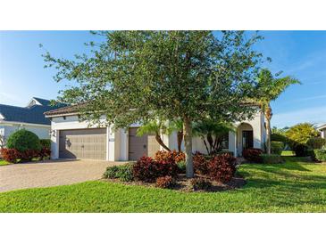 Charming single-Gathering home featuring a well-manicured lawn and a welcoming three-car garage at 508 Wildlife Gln, Bradenton, FL 34209