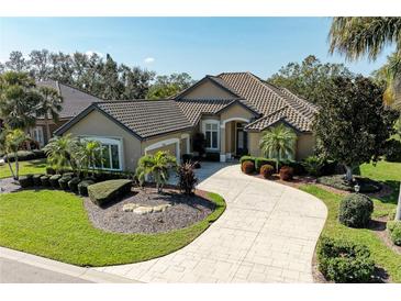 Beautiful single-Gathering home with a well-manicured lawn and lush landscaping at 5304 96Th E St, Bradenton, FL 34211