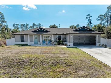 Charming single-story home with a well-manicured lawn, two-car garage and welcoming front entrance at 5551 Allamanda Ave, North Port, FL 34288