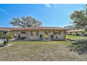 Charming single-story home with a well-maintained lawn, mature trees, and a welcoming entrance at 4565 Mohican Trl # 129, Sarasota, FL 34233