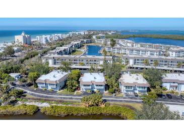 Aerial view of waterfront community with lush landscaping and private boat docks at 527 Sutton Pl # T-12, Longboat Key, FL 34228