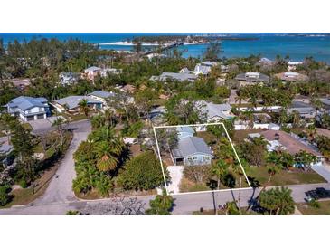 Aerial view of a single-story home with a metal roof, located in a residential neighborhood at 651 Fox St, Longboat Key, FL 34228