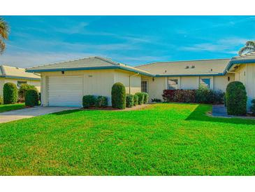 Well-maintained house with a lush lawn and attached garage at 7003 9Th W Ave, Bradenton, FL 34209