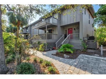 Charming two-story home with a private balcony and a landscaped front walkway at 1447 Landings Cir # 68, Sarasota, FL 34231