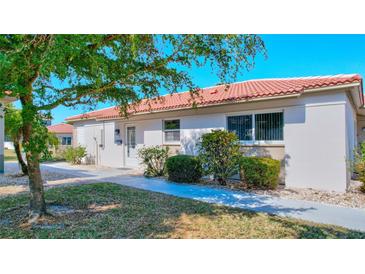 Charming villa featuring a red tile roof and well-maintained landscaping at 185 Vista Hermosa Circle, Sarasota, FL 34242