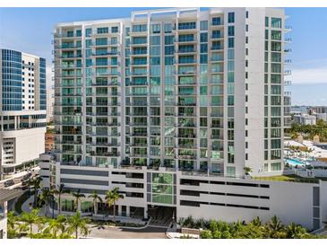 Luxury high rise condo building features modern architecture, balconies, and stunning city views at 301 Quay Commons # 1809, Sarasota, FL 34236