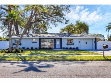 Beautiful single-story home with manicured lawn, updated exterior, and charming curb appeal at 3446 Monica Pkwy, Sarasota, FL 34235