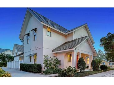 Charming two-story home featuring a modern architectural design, metal roof, and well-manicured landscaping at 515 S Osprey Ave, Sarasota, FL 34236