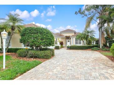 Beautiful home exterior featuring a well-manicured lawn and a brick driveway at 7327 Kensington Ct, University Park, FL 34201