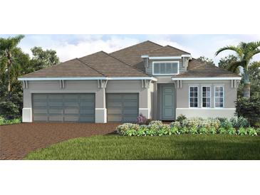 Two-story home with gray exterior, two-car garage, and landscaped front yard at 12440 Meribel St, Venice, FL 34293