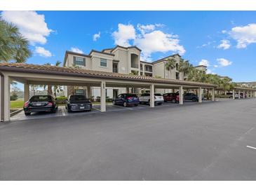 View of the covered parking area near the condo building, offering convenient and protected parking spaces at 16904 Vardon Ter # 102, Bradenton, FL 34211