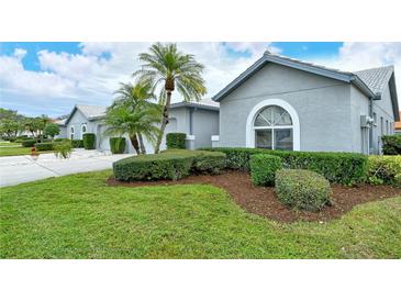 Gray house with palm trees and well-manicured lawn at 4147 Marseilles Ave # 3068, Sarasota, FL 34233