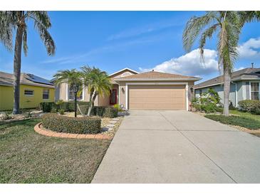 Charming single-story home with a two-car garage and lush landscaping at 4969 Creekside Trl, Sarasota, FL 34243