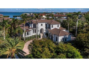 Beautiful waterfront estate featuring lush landscaping and impressive architectural details at 500 Harbor Point Rd, Longboat Key, FL 34228