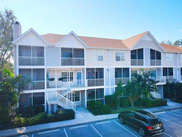 Two-story condo building with balconies, landscaping, and parking at 850 S Tamiami Trl # 724, Sarasota, FL 34236