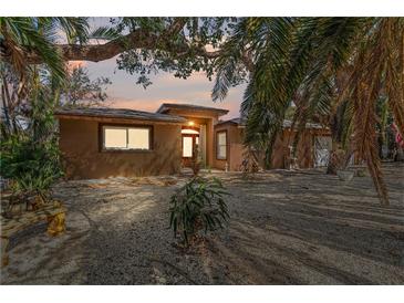 Charming single-story home featuring desert landscaping and a natural wood front door at 951 Contento St., Siesta Key, FL 34242