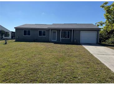 Charming single-story home with well-maintained lawn and attached one car garage at 18053 Ohara Dr, Port Charlotte, FL 33948