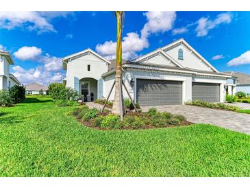 Charming home with a well-manicured lawn, beautiful landscaping, and a two-car garage at 2622 Light Sky Ln, Bradenton, FL 34211