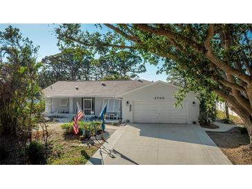 Charming single-story home with a two-car garage, well-kept lawn, and inviting curb appeal at 2760 Siesta Dr, Venice, FL 34293