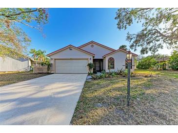 Charming single Gathering home featuring a well-manicured lawn and mature trees at 4920 82Nd E Pl, Sarasota, FL 34243