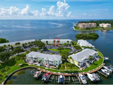 Stunning aerial view of waterfront condos with boat docks and beautiful blue water views at 5282 Beach Se Dr # D, St Petersburg, FL 33705