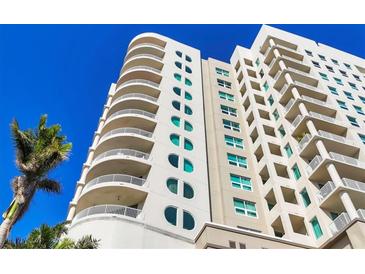 Stunning high-rise condo building featuring curved balconies and blue sky backdrop at 1771 Ringling Blvd # 703, Sarasota, FL 34236