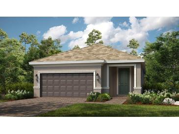 Charming single-story home featuring a two-car garage, neutral color palette, and well-maintained landscaping at 26936 Lark Ct, Punta Gorda, FL 33955