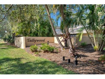 Well-maintained Tallywood community entrance sign, featuring a large grass and mulched area at 3417 Tallywood Ln, Sarasota, FL 34237