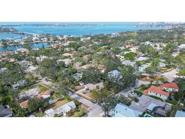 Sprawling property with mature trees on a street ending at the bay, near open water and beaches at 3716 Camino Real, Sarasota, FL 34239